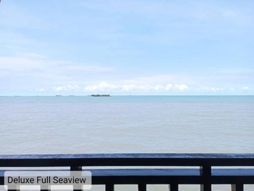 a view of the ocean with an island in the distance at Alpine LXPD Full Seaview Water Chalet in Port Dickson