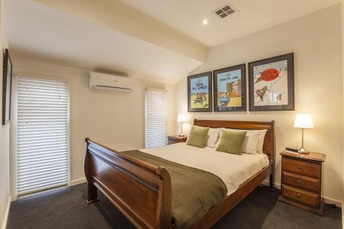a bedroom with a large bed and two windows at Boutique Stays - Elwood Hideaway in Melbourne