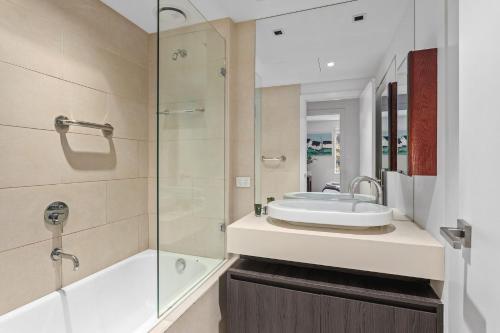 a bathroom with a sink and a shower at Boutique Stays - Lalique in Melbourne