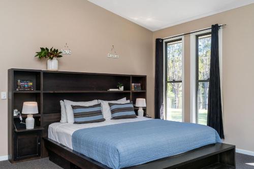 a bedroom with a large bed and a window at A Perfect Stay - Lennox Coastal Retreat in Lennox Head