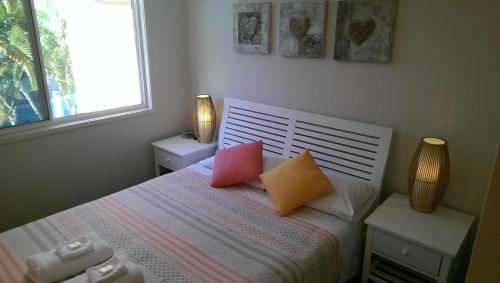 a bedroom with a bed with two pillows on it at Sails Lifestyle Resort in Peregian Beach