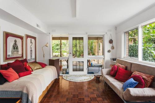 a living room with a large bed and a couch at Boutique Stays - That 70s House in Mount Waverley