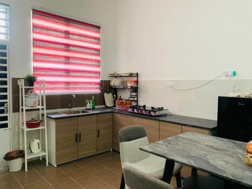 A kitchen or kitchenette at HOMESTAY HONEY PARIT BUNTAR