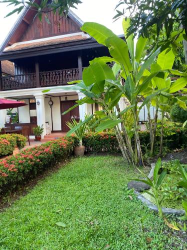 a garden in front of a house at Luang Prabang Residence & Travel in Luang Prabang