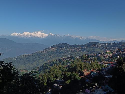 a view of a city with mountains in the background at Wonder Hill Parivaar homestay in Darjeeling