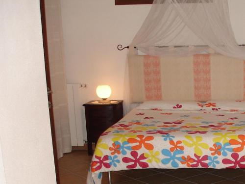 Tempat tidur dalam kamar di La Valle Dei Corbezzoli