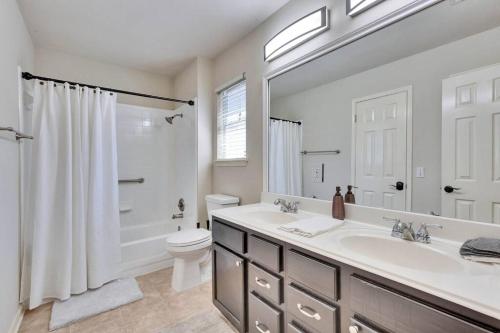 a bathroom with a sink and a shower and a toilet at Charming and Comfort 3BR/2BA Retreat in Kyle in Kyle