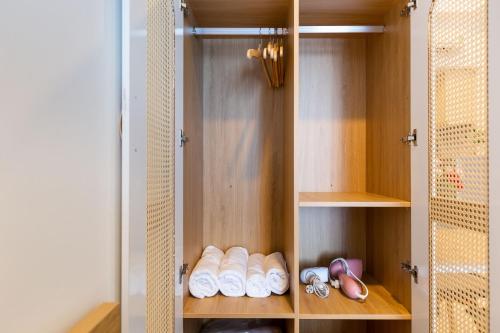 a closet with several pairs of shoes in it at Le May Home Rivergate Luxury Apartment Near Ben Thanh in Ho Chi Minh City