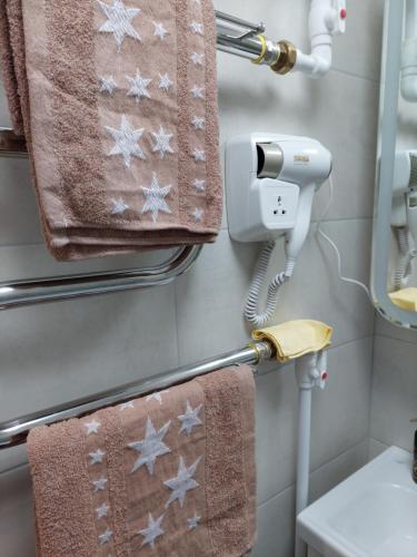 a bathroom with towels hanging on a towel rack at Квартира in Karagandy