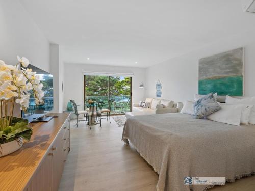 a bedroom with a bed and a living room at 341 The Waves, Cowes in Cowes