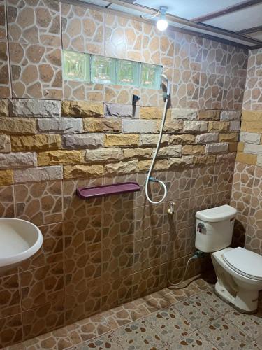 a bathroom with a toilet and a shower at Silver cliff in Than Sadet Beach