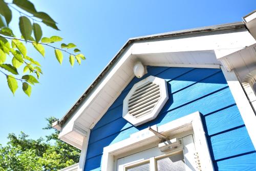 a blue house with a window at Yangyang Pulbit Pension in Yangyang