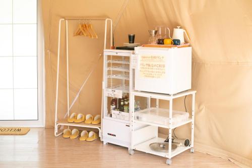 a white cart in a room with shoes at glampark Healthy Pal Gunma in Shibukawa