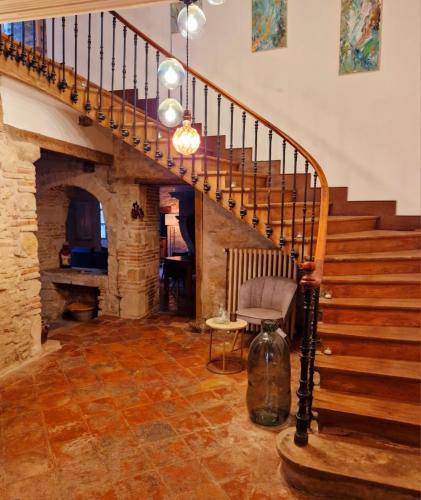 a staircase in a home with a stone fireplace at L'écrin in Lacroisille
