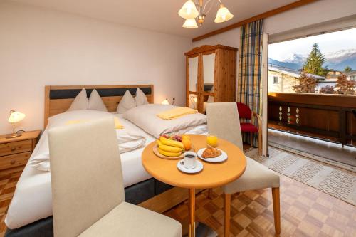 a hotel room with a bed and a table with fruit on it at Villa Frieda mit Zell am See-Kaprun Summer Card in Zell am See