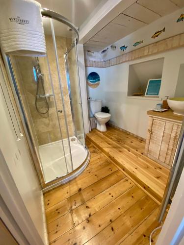 a bathroom with a shower and a toilet at The Beach House-Devon- On the beach- sleeps 20 in Exmouth