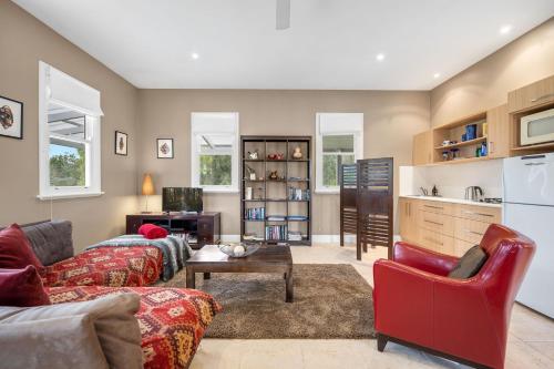 a living room with a couch and a table at Lastover Cottage in Wattamolla