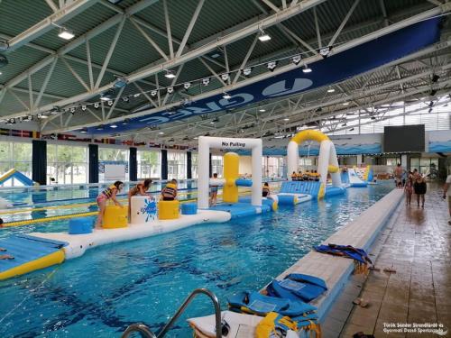 a large indoor swimming pool with people in it at Hód-Thermal Camping in Hódmezővásárhely