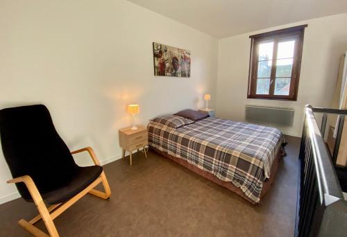 a bedroom with a bed and a chair and a window at Le Nid Dieppois - Sur les Quais de Dieppe, Entre Port & Plage in Dieppe