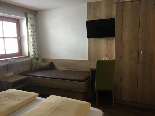 a small room with two beds and a window at Mönchsberghof in Kleinarl