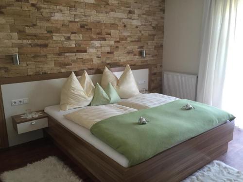 a bedroom with a large bed with a brick wall at Appartement Mühlbacher in Wagrain