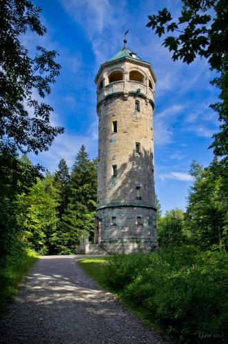 a tall stone tower sitting on the side of a road at Hotel Alter Wirt in Weyarn