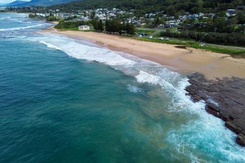 an aerial view of a beach with the ocean at 'rockpool' - Direct Beach Access in Coledale