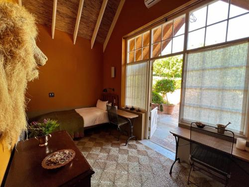 a bedroom with a bed and a large window at 7 Koppies in Franschhoek