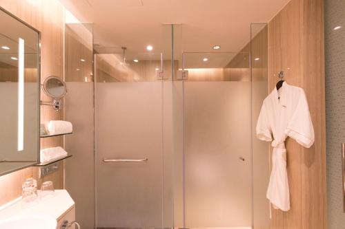 a shower with a glass door in a bathroom at Lancaster Bangkok in Bangkok