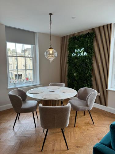 a dining room with a table and chairs at Haus of Sulis, City Centre Apartment with Lift Access in Bath