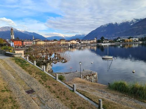 a town on a lake with mountains in the background at Casa Martangelo in Arbedo-Castione