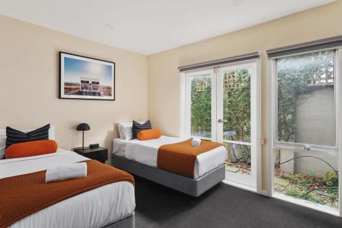 a bedroom with two beds and a window at Boutique Stays - Roxys Place in Melbourne