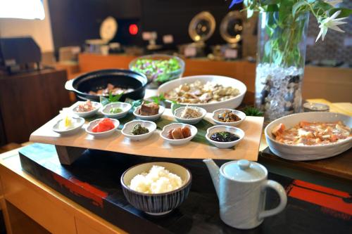 a tray of food on a table with bowls of food at Rembrandt Style Tokyo Nishikasai Grande in Tokyo