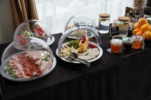 a black table with plates of food on it at Hotel Clipa in Drobeta-Turnu Severin