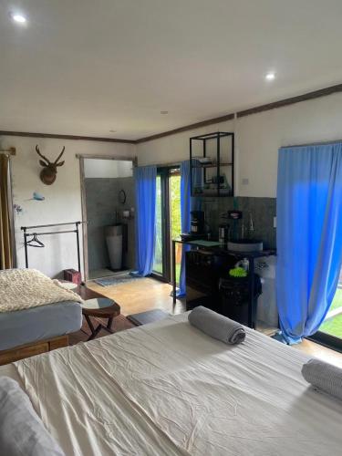 a bedroom with a bed and blue curtains in it at Torio sea view in Torio