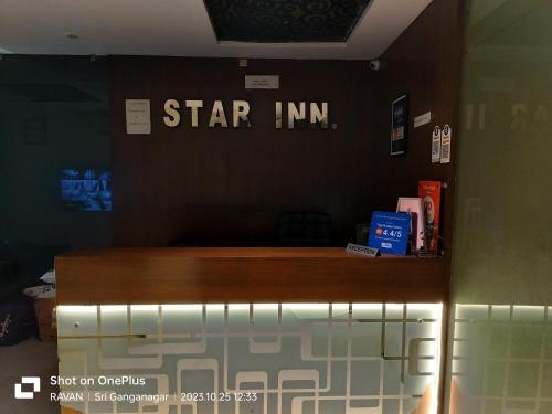 a star inn sign on the wall of a room at Hotel Star Inn in Gangānagar