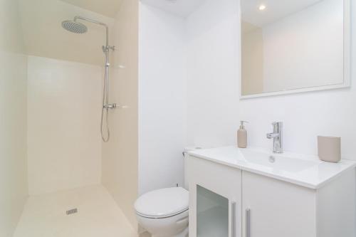 a bathroom with a toilet and a sink and a mirror at Can Serral in Algaida