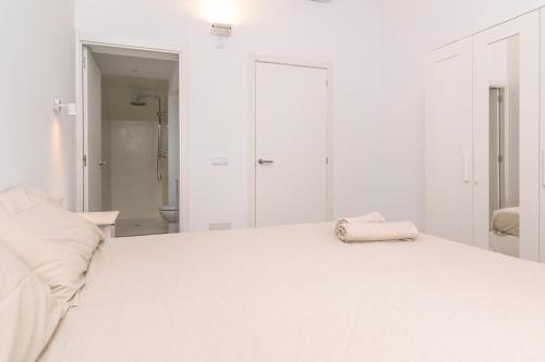 a white bed with a towel on top of it at Can Serral in Algaida