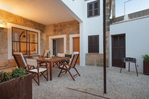 a patio with a wooden table and chairs at Can Serral in Algaida