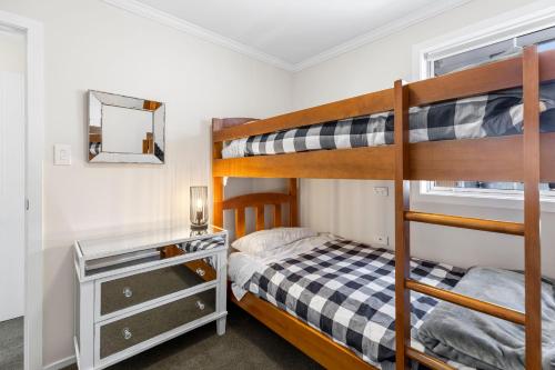1 Schlafzimmer mit 2 Etagenbetten und einem Spiegel in der Unterkunft It's Easy! Space and comfort in Wanaka