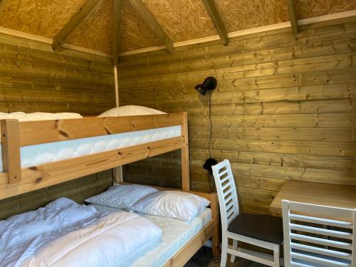 a bedroom with two bunk beds and a desk at Winjum Cabin Aurland Stegastein in Aurland