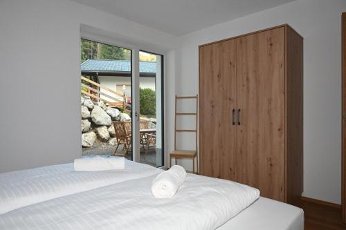 a bedroom with two beds and a large window at Alpin 1100 in Steeg