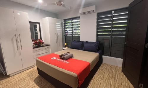 a bedroom with a bed with a camera on it at GreyStone Apartments in Nadi