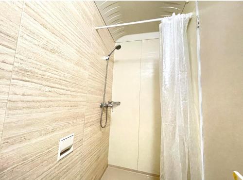 a shower with a shower curtain in a bathroom at E-COMMERCE - EASTWOOD in Manila