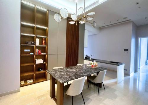 a dining room with a marble table and chairs at NEW Charming 2BR Apartment in Central Jakarta in Jakarta