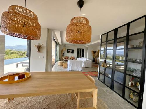 a dining room with a table and two lights at Villa Cala Rossa in Lecci