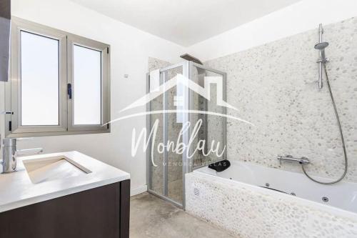a bathroom with a shower and a tub and a sink at Villa Colom in Son Carrio