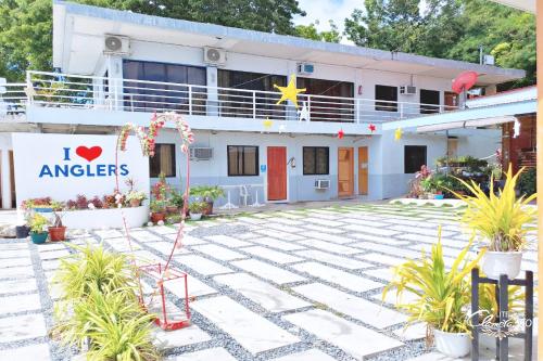 a building with a sign that reads i love angels at Angler's Hub & Resort Oslob in Oslob