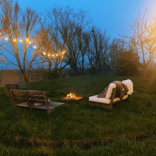 a bed and a fire in a field with afire at Les Jardins de Jeanne in Middelkerke