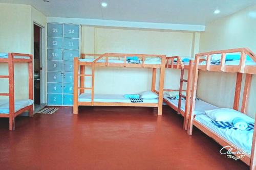 a room with three bunk beds in it at Angler's Hub & Resort Oslob in Oslob